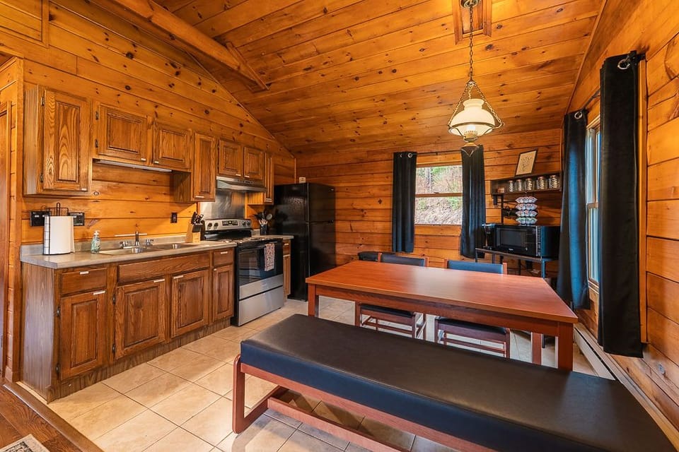 Open-concept kitchen and dining area with full appliances and seating for up to five—perfect for meals or game night.