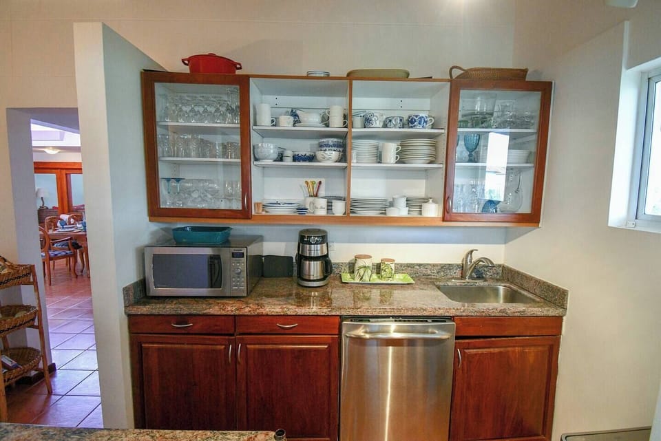 This is the butler pantry with sink and dishwasher.  The window has recently been replaced with a door that leads to the carport giving you direct access to the golf cart.  Also in this space is another refrigerator and the washer and dryer.