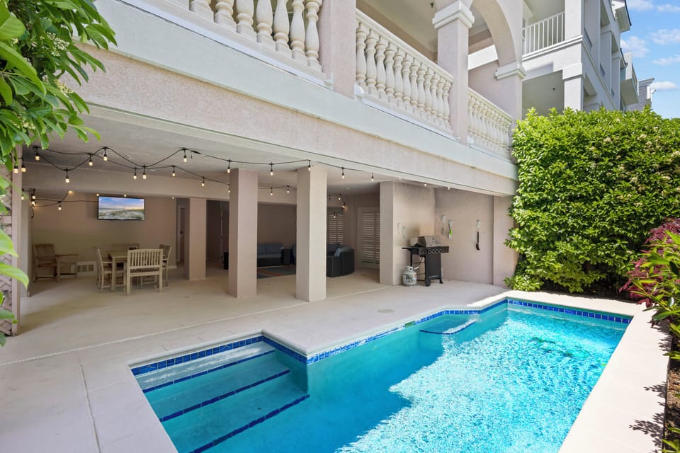 HOST & HOME presents… 21 Crabline Court! Private Pool Oasis: Relax poolside under a covered patio complete with plush furniture, smart TV, BBQ grill with al fresco dining options.