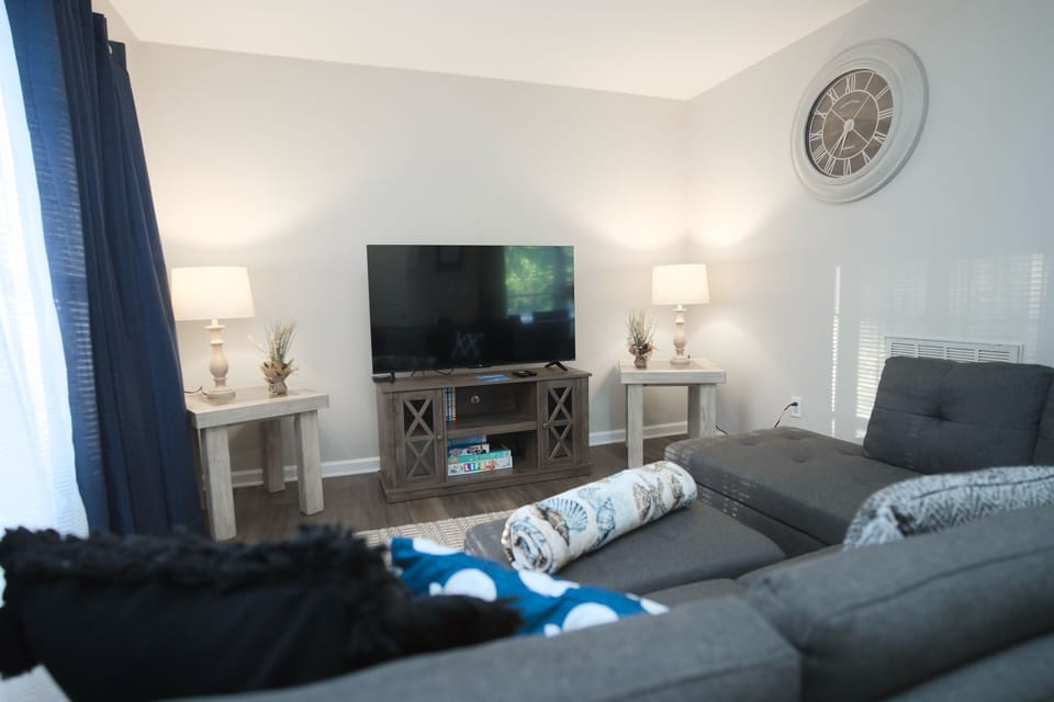 Relax in our inviting living space, featuring a modern gray sectional sofa