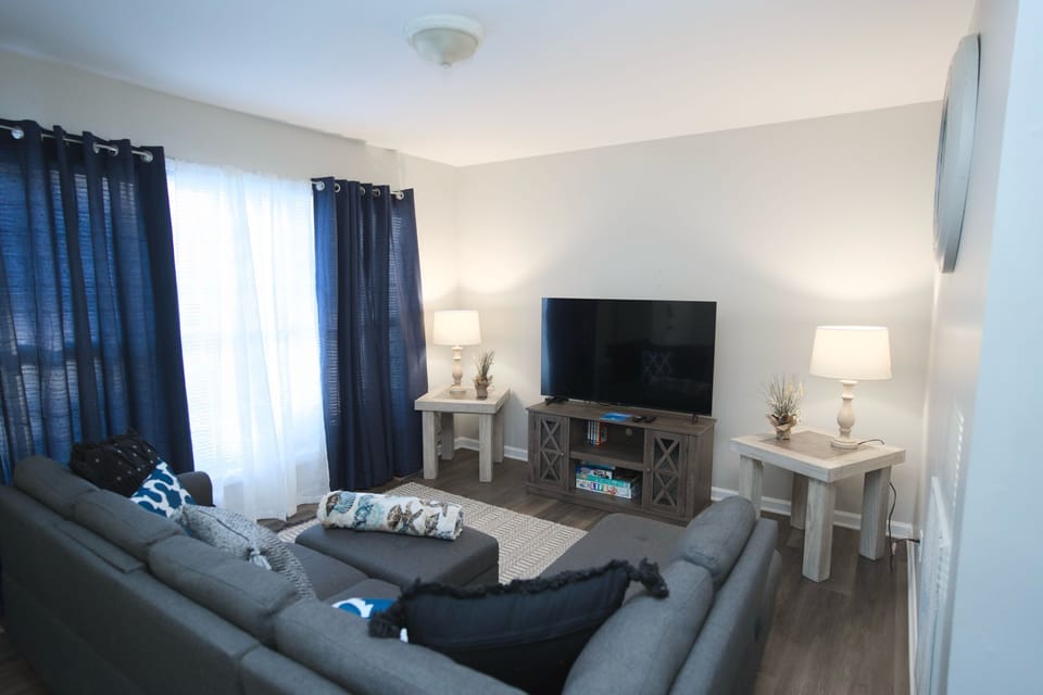 Relax in our inviting living space, featuring a modern gray sectional sofa.