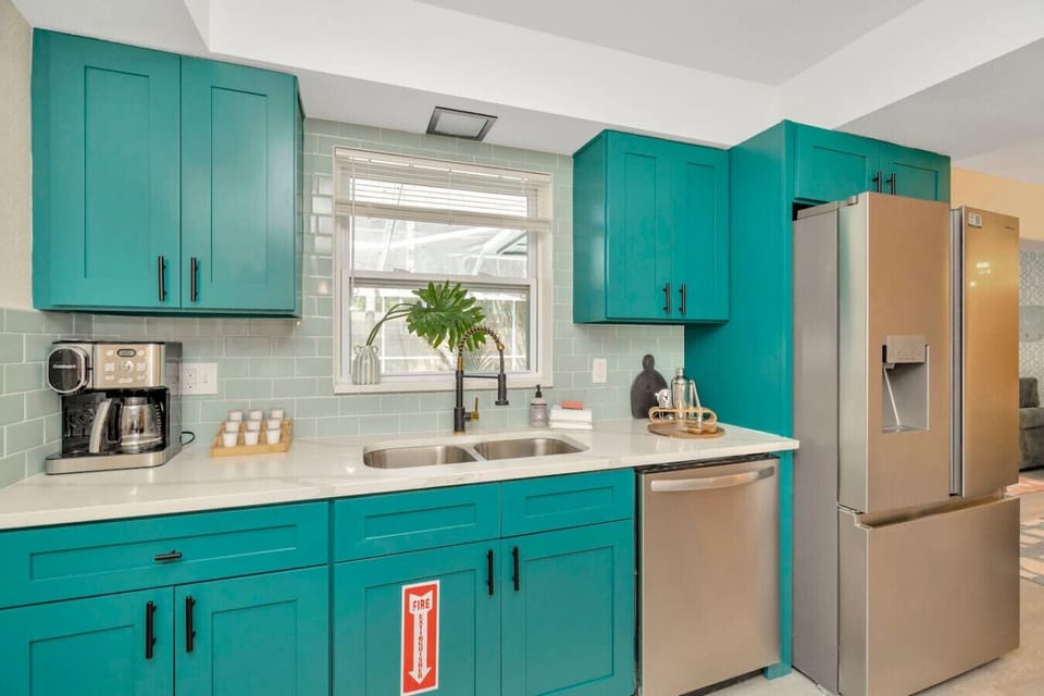 Cook in color — this bright kitchen is fully stocked for family meals, morning coffee, and late-night snacks