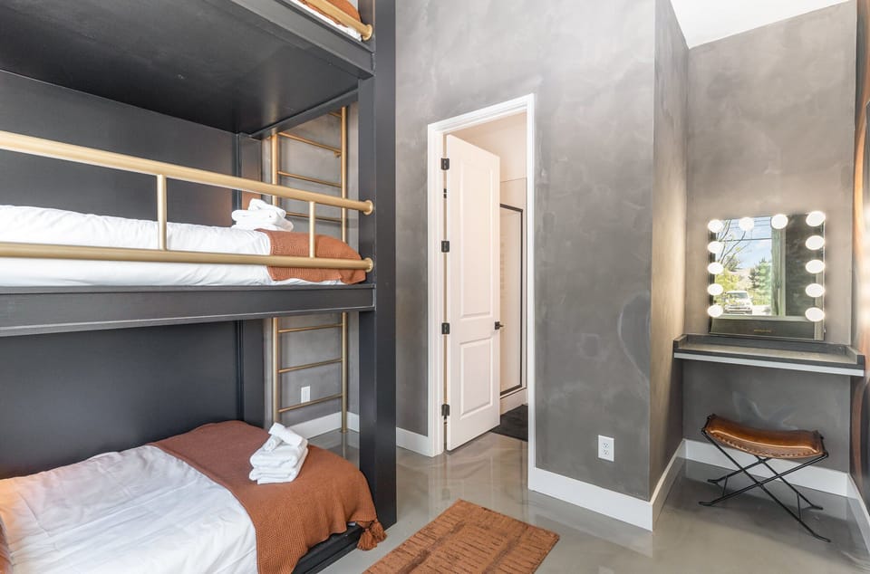 1st Floor: 4th Bedroom featuring a Bunk Bed with 3 Full beds, Get Ready Vanity, Smart TV, and en-suite bathroom.