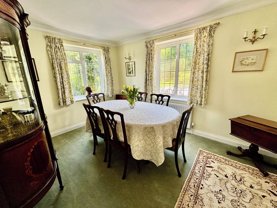 Dining Room furnished in classic style for family dinners.  Adjacent to the kitchen through arched doorway