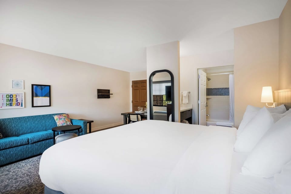 Recharge in a serene bedroom with lounge space nearby.