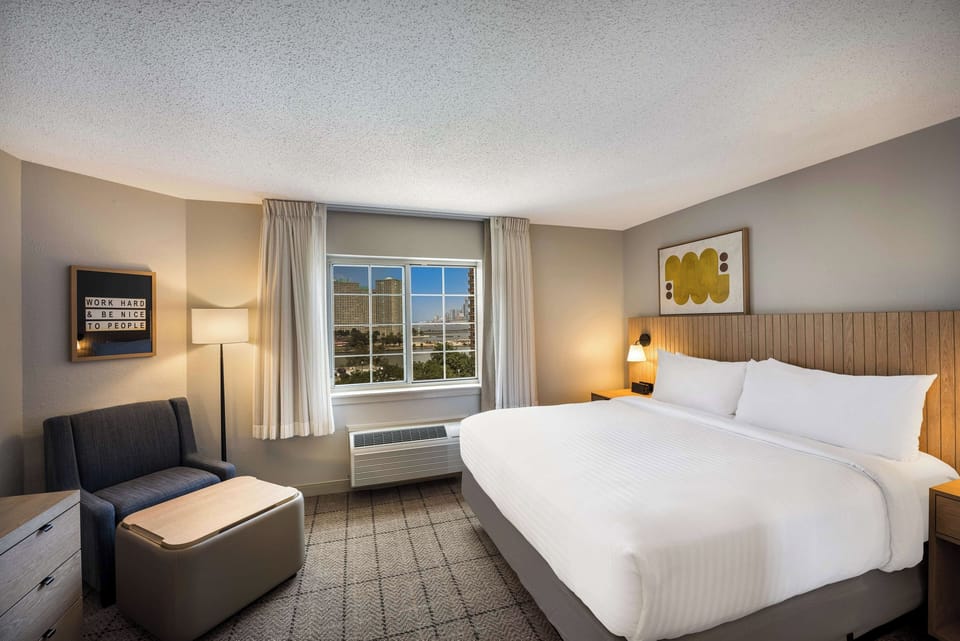 Unwind in crisp linens and enjoy calming skyline views.