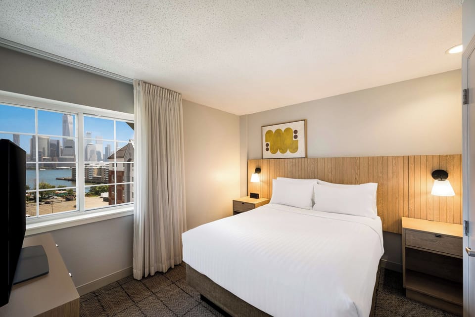 Wake up to skyline views from a plush, cloud-soft bed.