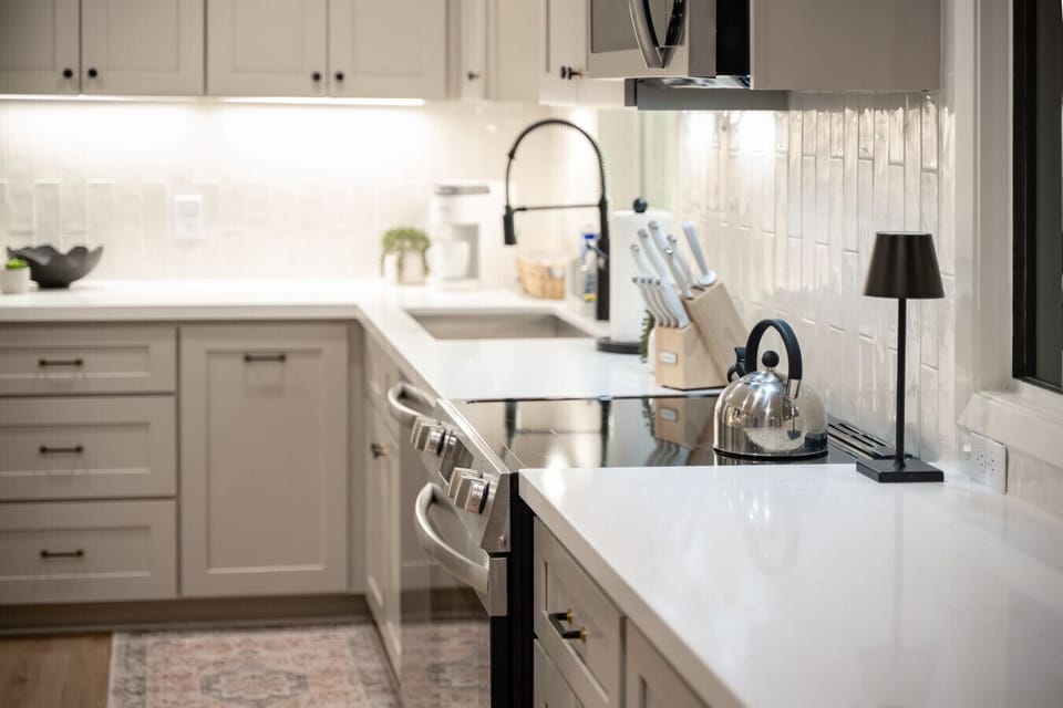 Beautiful kitchen with single bowl sink, electric range and fully stocked