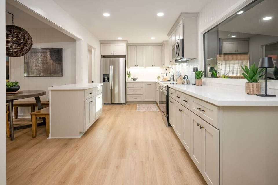 Large kithen with ample counter space, electric range, serving bar and everything you need to make a meal at home
