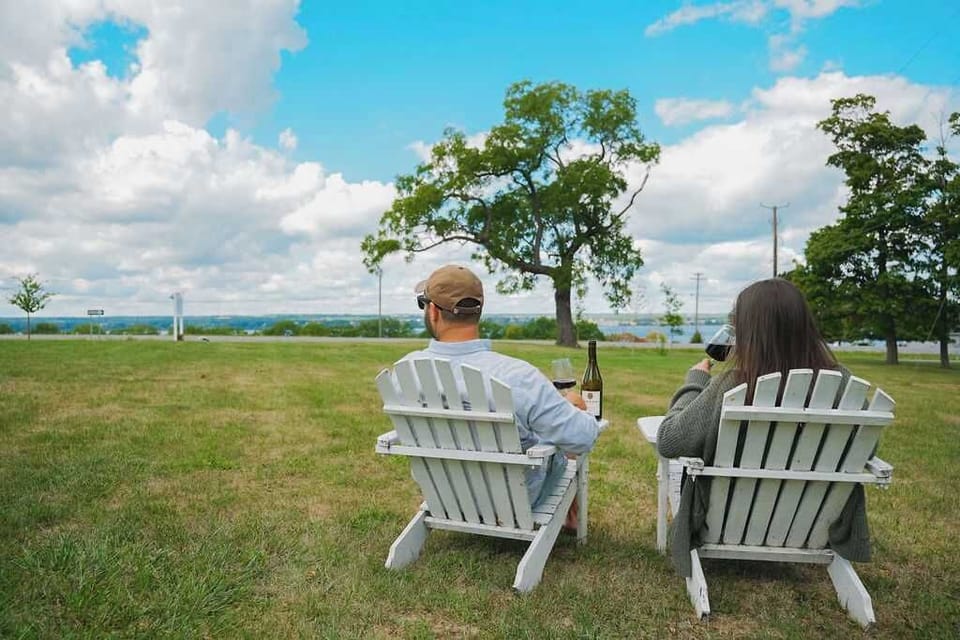 Unwind on the cottage lawn with wine and lake views.