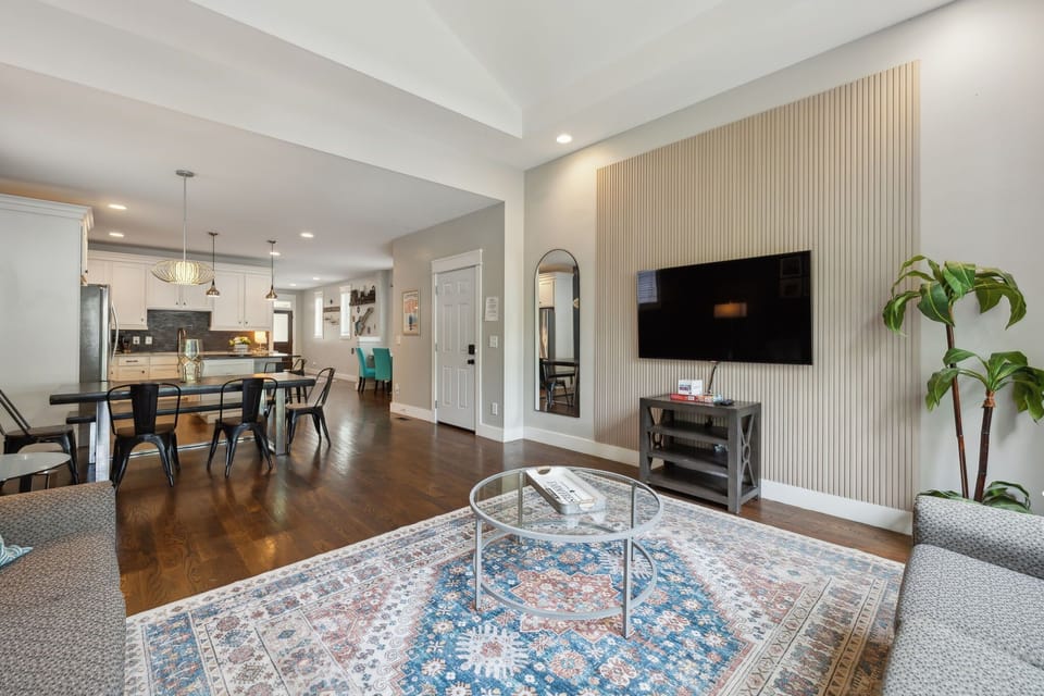 Living Room: Golden drapes, plush seating, and a sleek TV console create a warm, modern vibe. A perfect place to relax or entertain.