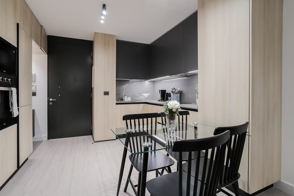 Sleek modern kitchen with stylish dining area, perfect for cozy meals and gatherings.