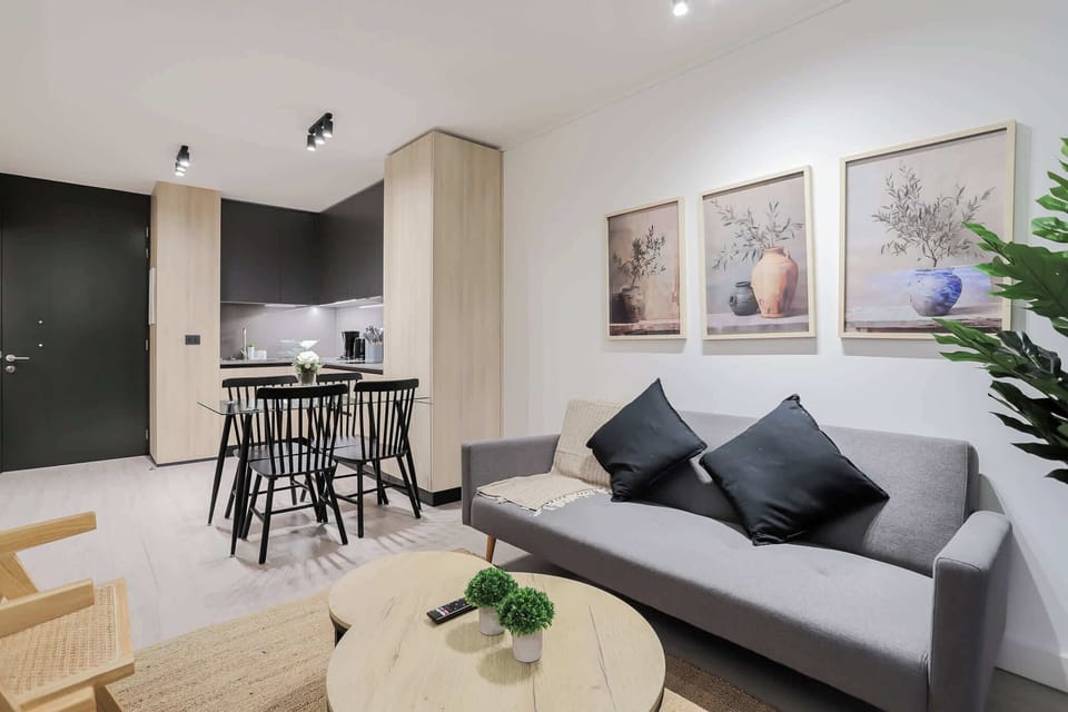 Experience modern comfort in this stylish living area, complete with a cozy sofa, chic dining space, and sleek kitchen.