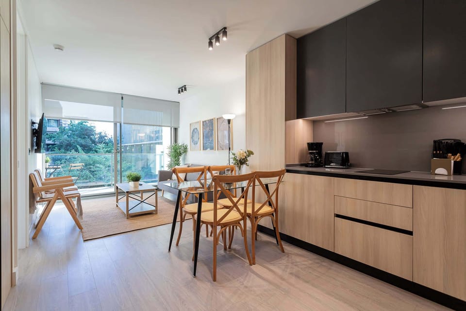Bright and modern living space with a stylish kitchen and dining area, perfect for relaxing and enjoying the view.