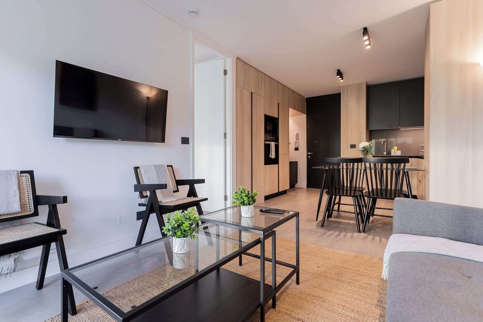 Experience modern comfort in this stylish living space, featuring a cozy dining area and sleek kitchenette for your perfect getaway.