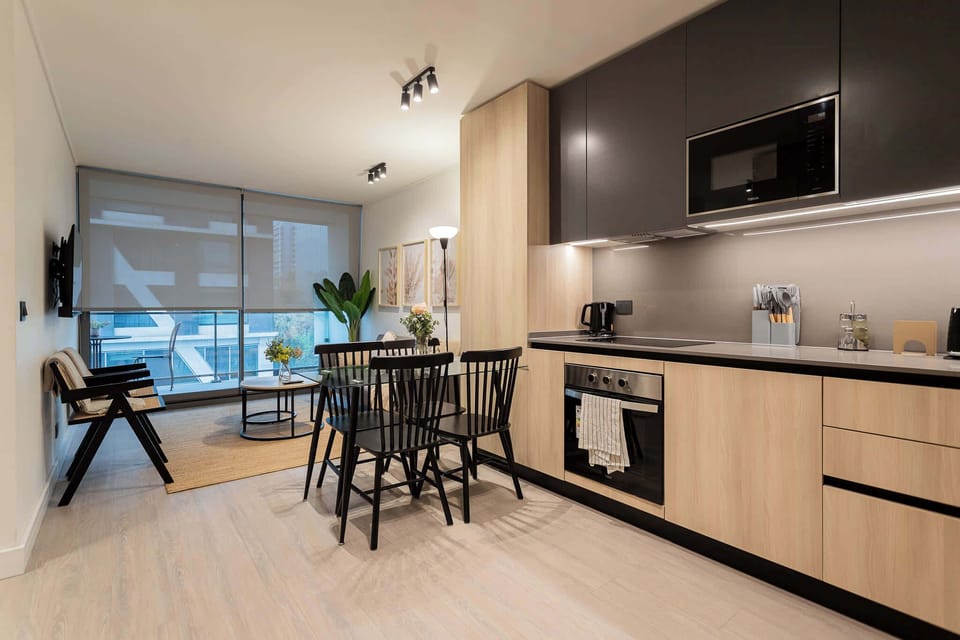 Experience modern elegance in this stylish kitchen and dining area, perfect for cozy meals and gatherings.
