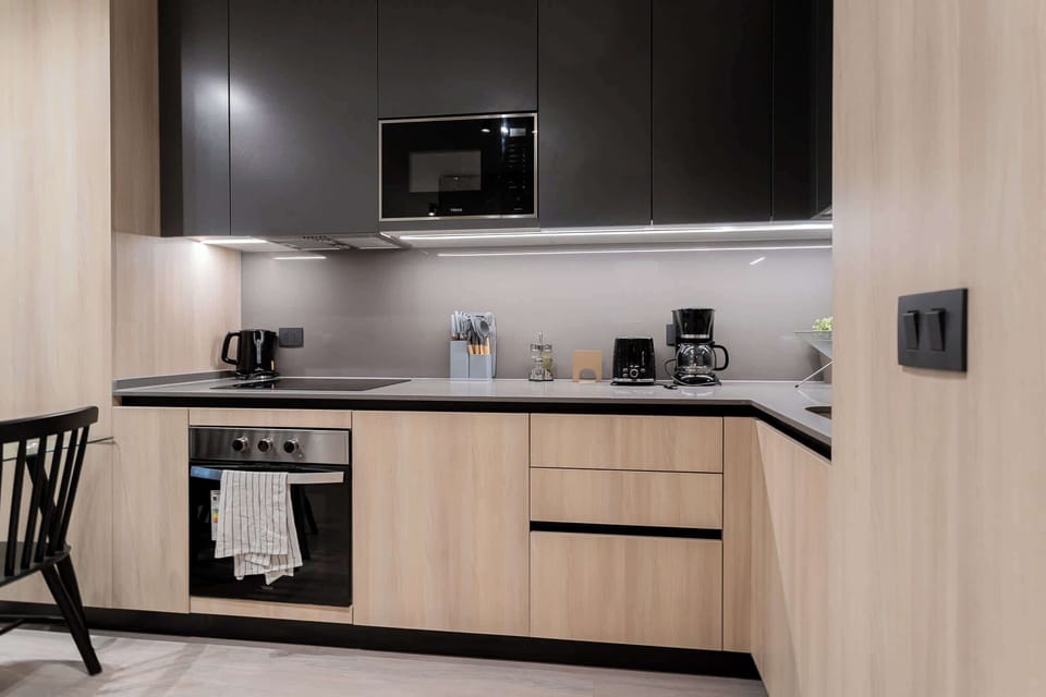 Sleek and modern kitchen equipped with all essentials for a cozy culinary experience.