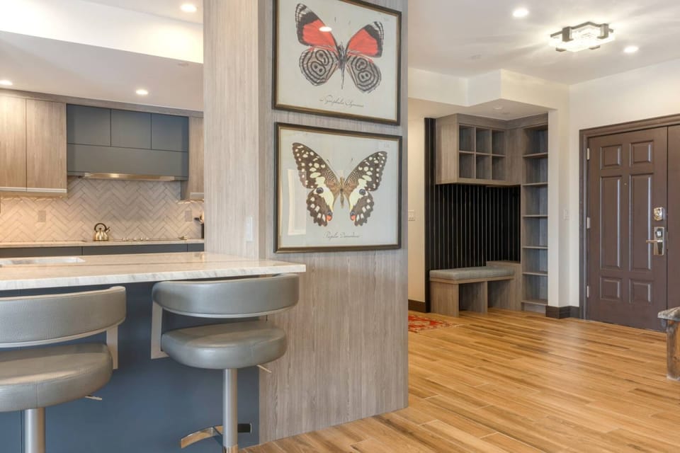 Welcoming entryway with ample storage opens to a modern kitchen.