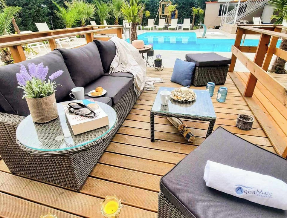 Outdoor seating by the pool – Comfortable lounge area near the pool, ideal for relaxation.

