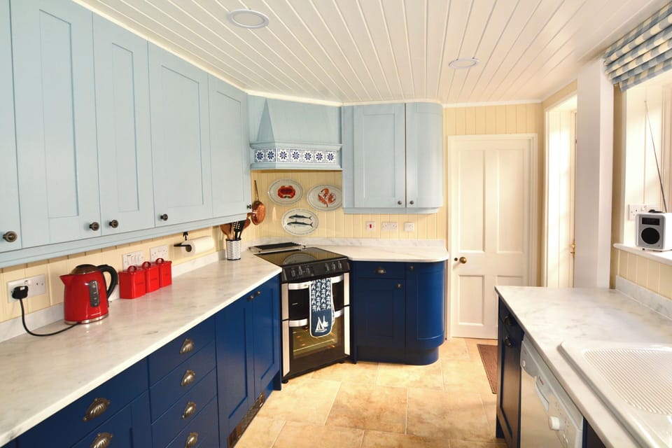 Very well equipped kitchen, with door to small utility room with washing machine