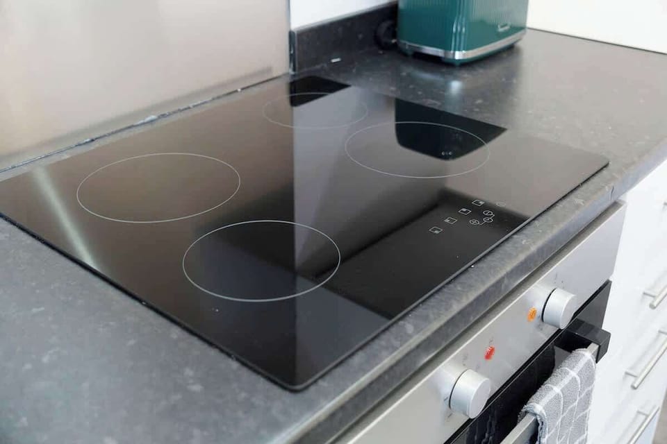 Kitchen equipped with all essentials, including a washer & dryer, oven, fridge and full cookware set.