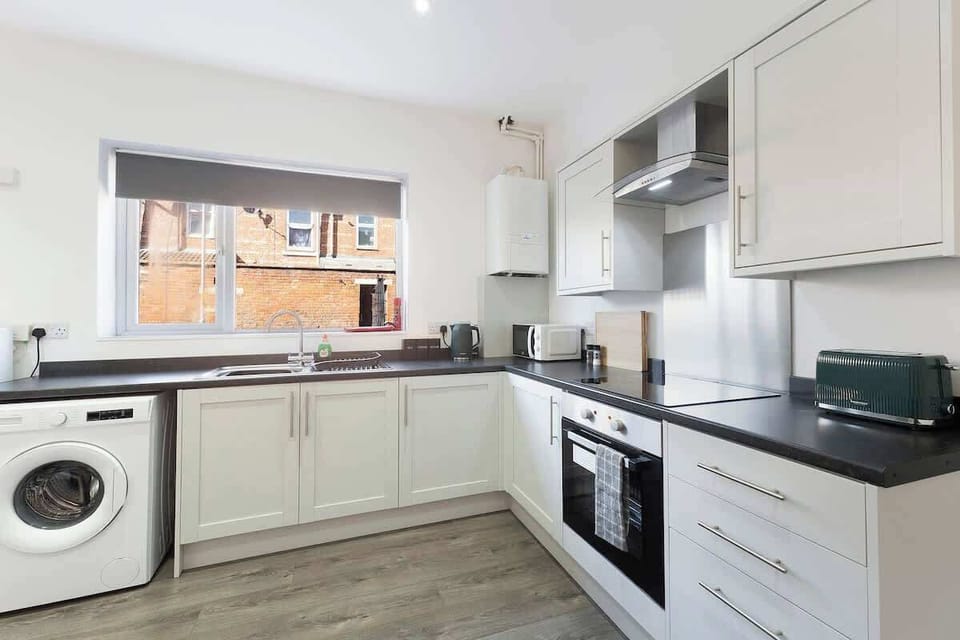 Kitchen equipped with all essentials, including a washer & dryer, oven, fridge and full cookware set.