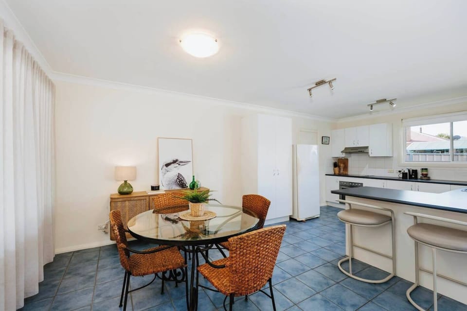 Styled with earthy textures, the dining area creates a relaxed setting for a slow breakfast or a shared meal with a bottle of local red.