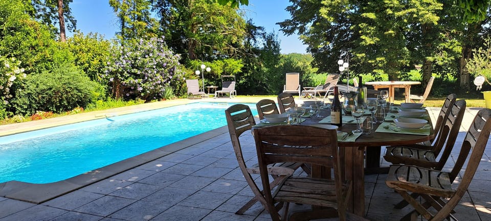 Pool dining table for 12, fantastic shade from the hot sun