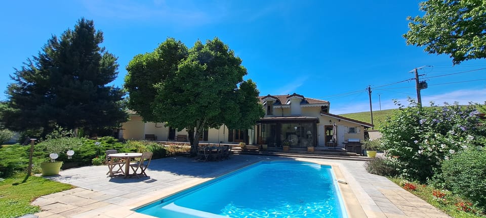 Pool in the full sun with dining shade under the wonderful Magnolia tree.