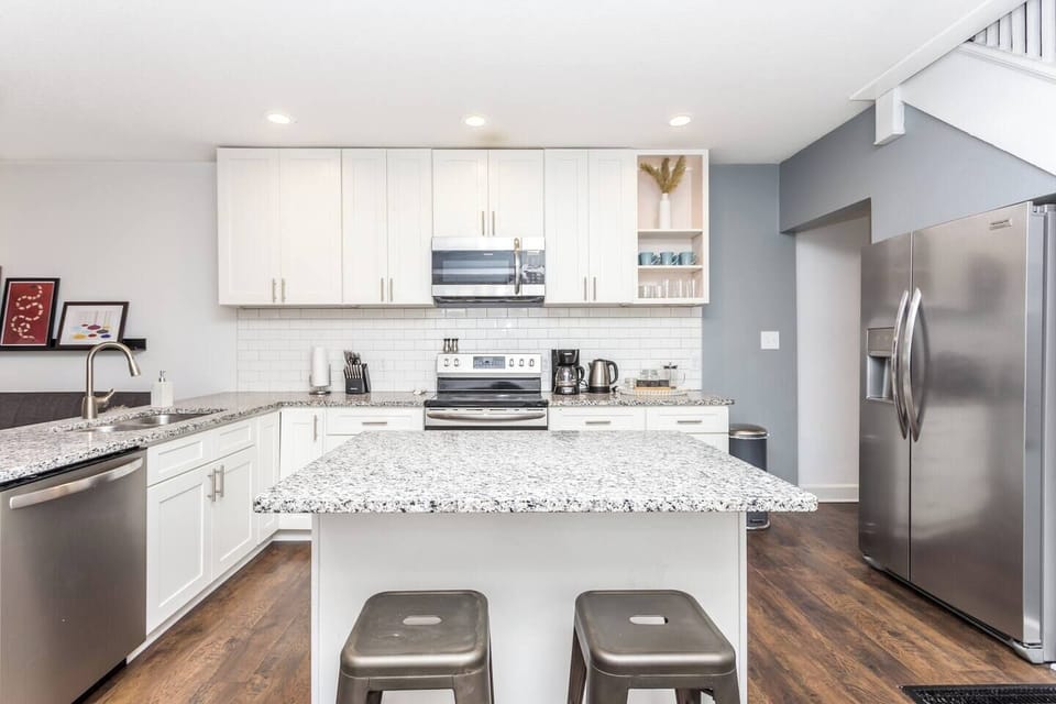 Island seating in the kitchen provides extra space for a quick breakfast or conversation.