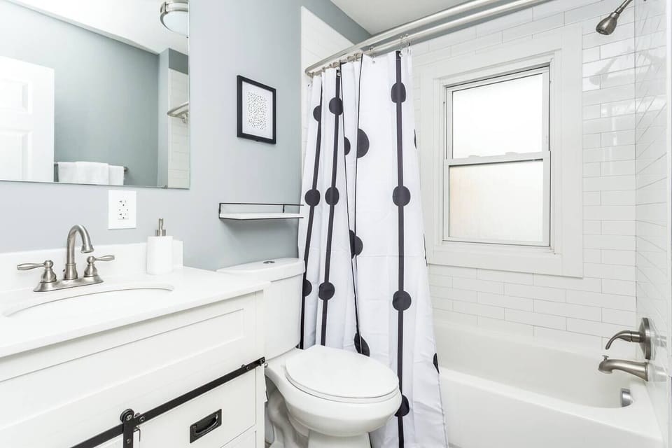 Guest bath offers a full size tub/shower with tile surround and luxury bath amenities.