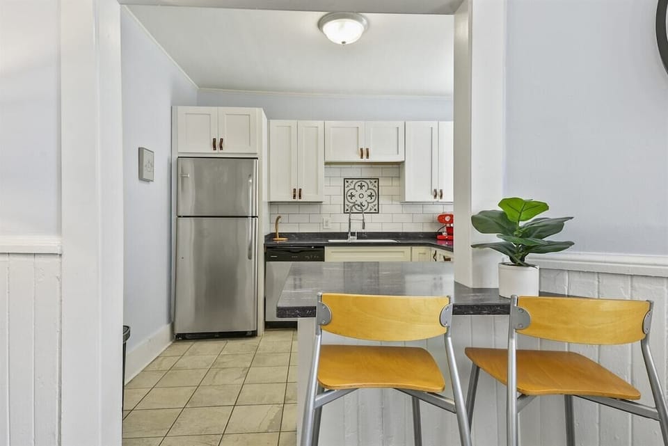 Sip and socialize at the bar, seamlessly connecting the living room and kitchen—complete with seating for two, perfect for intimate chats or quick bites!