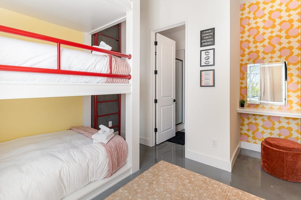1st Floor: 4th Bedroom featuring a Bunk Bed with 3 Full beds, Get Ready Vanity, Smart TV, and en-suite bathroom.