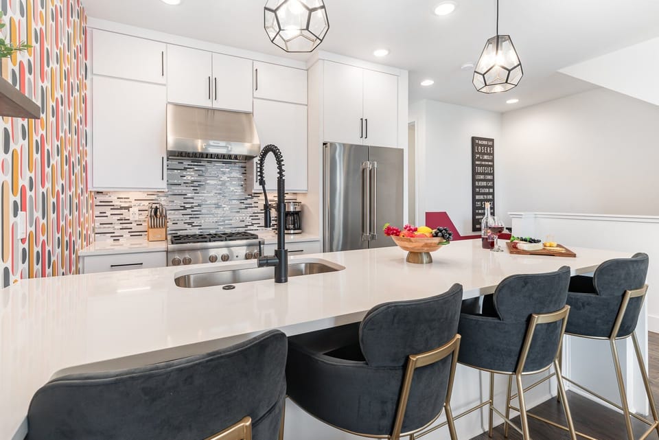 2nd Floor: Fully equipped kitchen with stainless steel appliances and a kitchen island with seating for 4 guests.