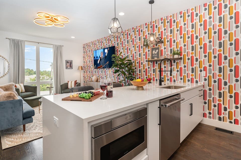 2nd Floor: Fully equipped kitchen with stainless steel appliances and a kitchen island with seating for 4 guests.