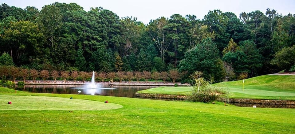 Tee off beside rolling greens and a calming waterside view.
