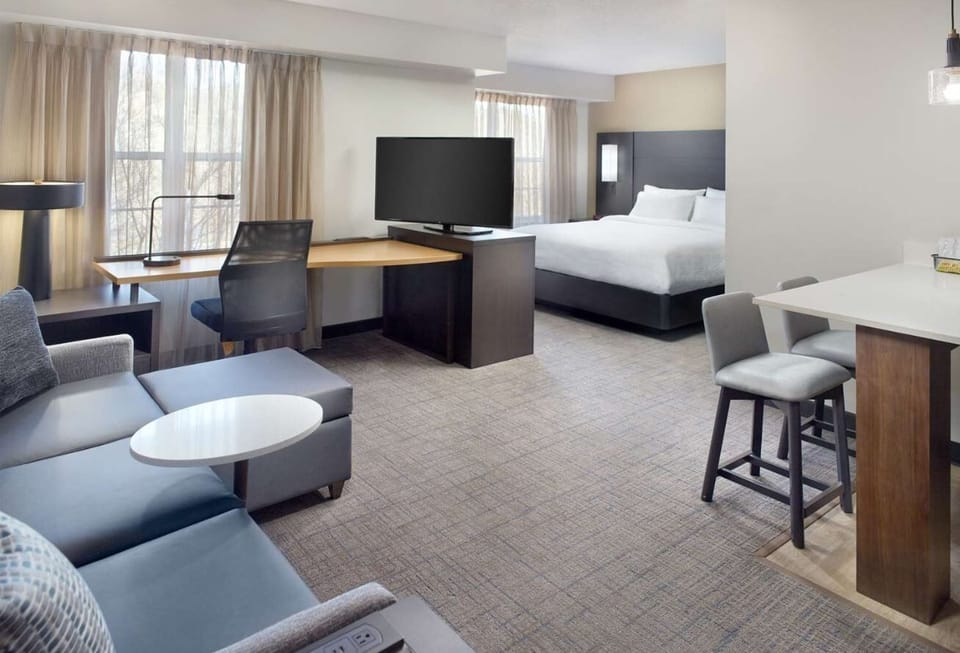 Unwind in a spacious suite with cozy bed and lounge.