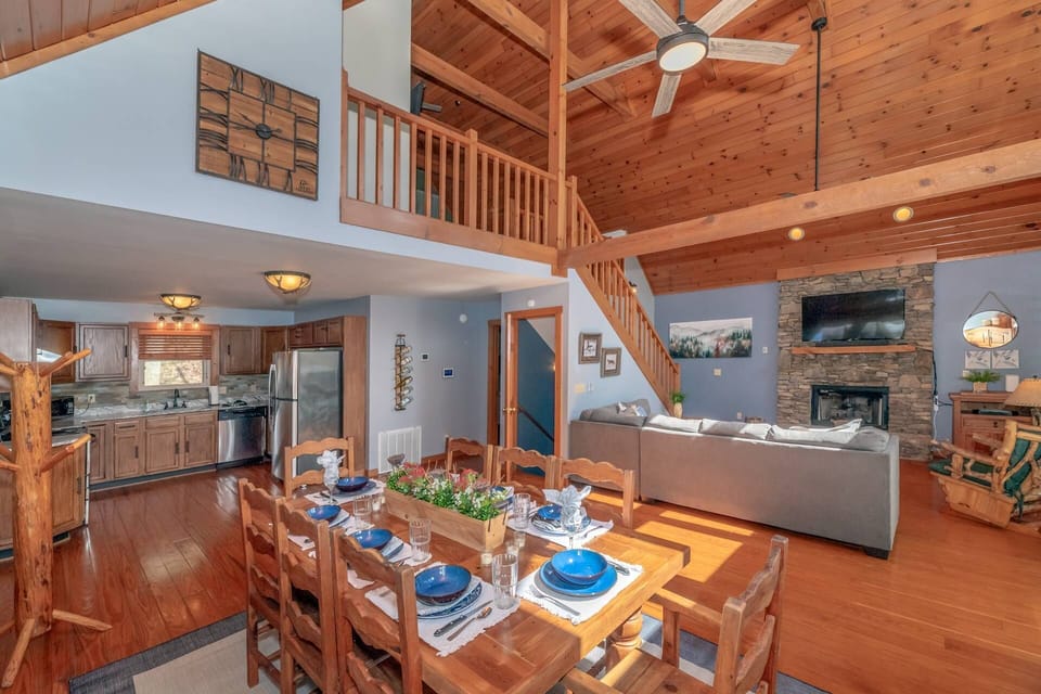 The beautiful open concept living space includes a seasonal fireplace, fully equipped kitchen and dining area for 8