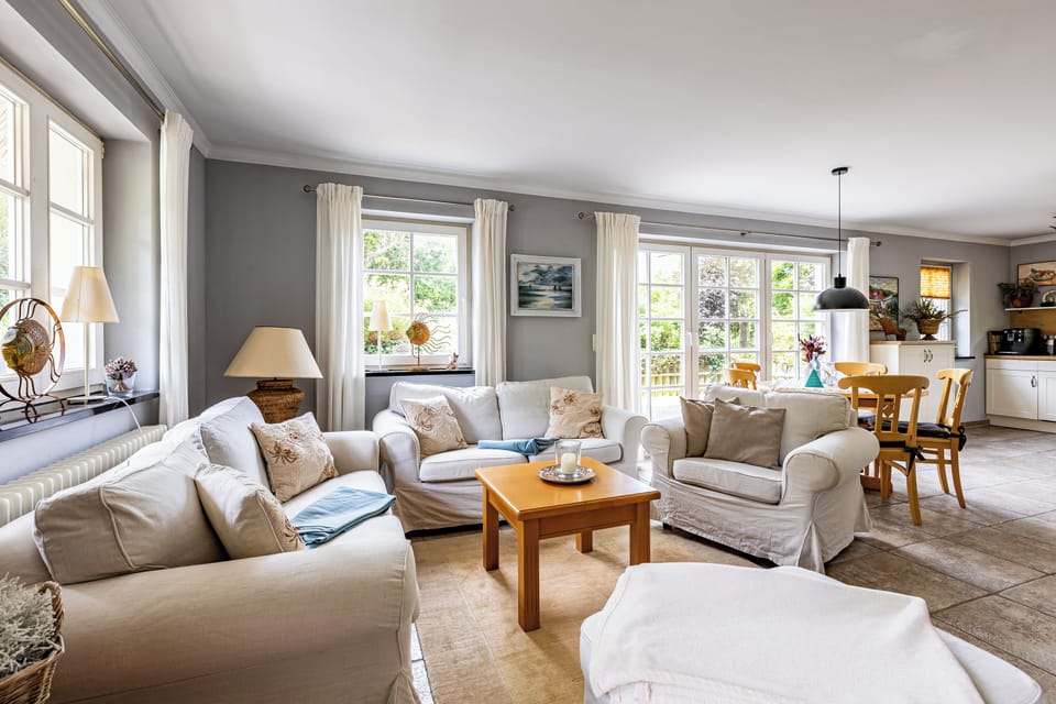 Cozy living room with sofas and dining table.