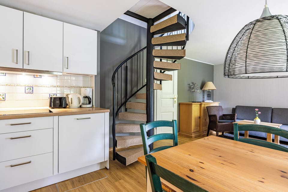 Modern Kitchen with Dining Table and Stairs