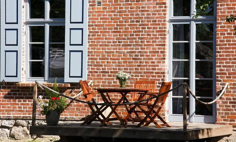 Terrace with table, flowers, and coffee mugs