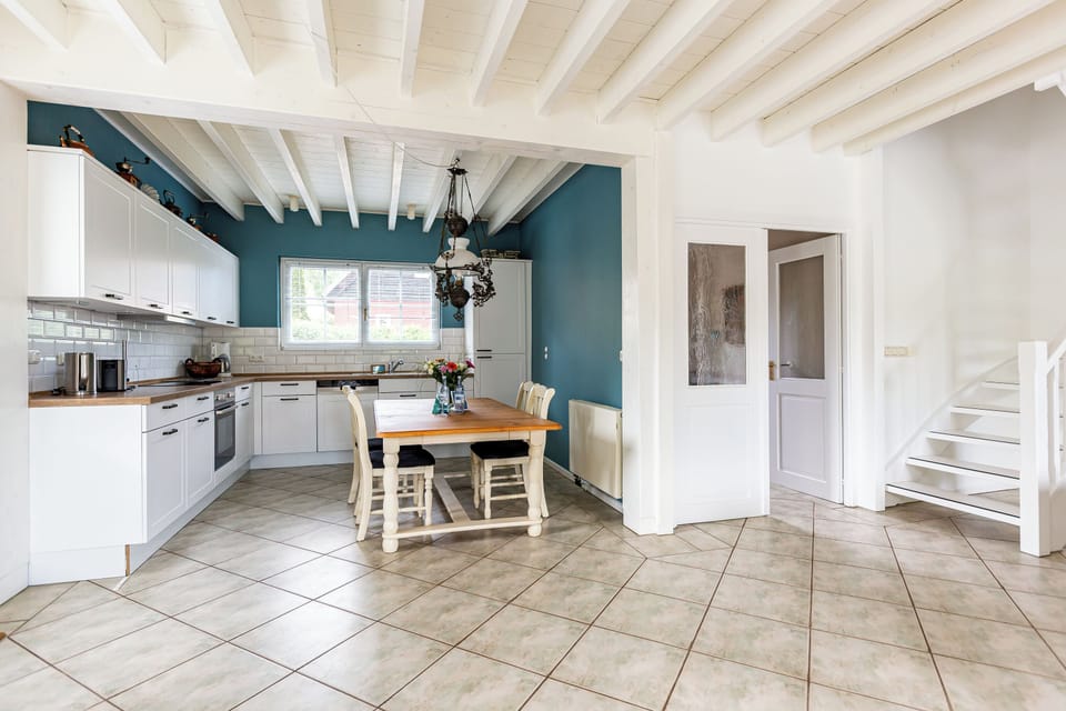 Modern Kitchen with Dining Table and High Windows