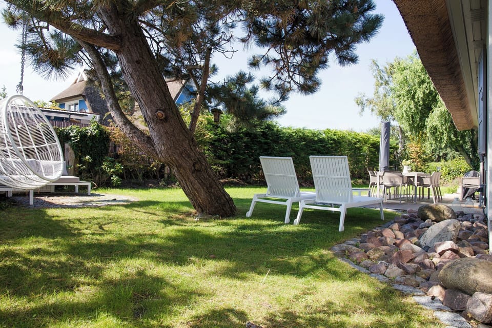 Terrace with Loungers and Dining Table in Garden