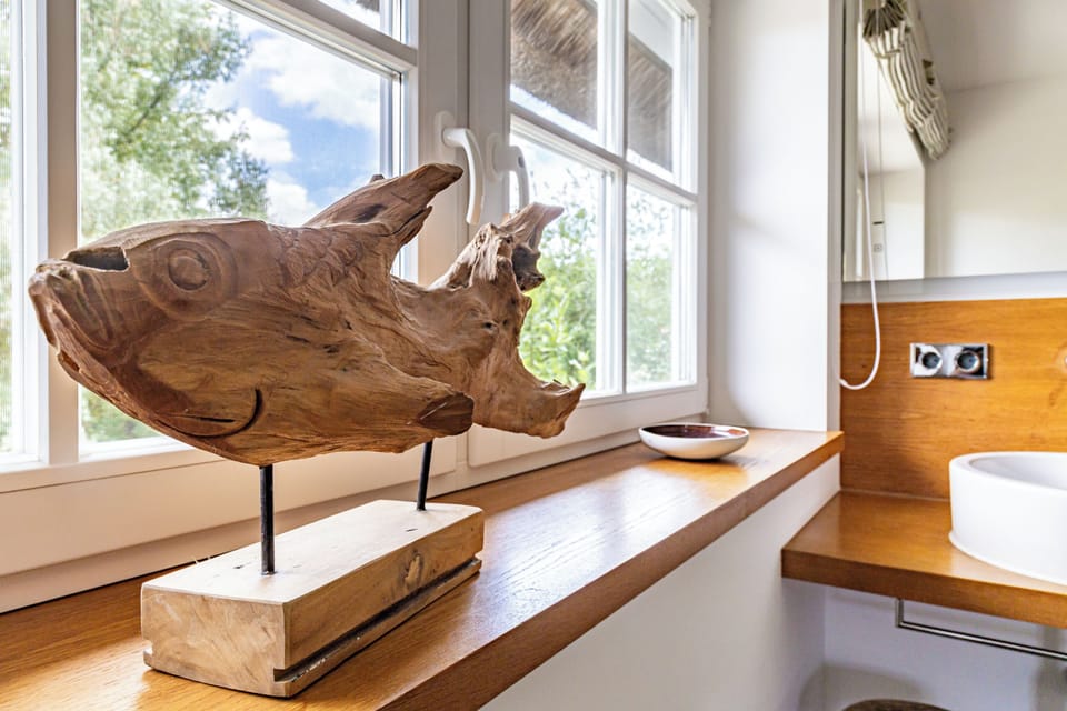 Bathroom with Wooden Sculpture and Window