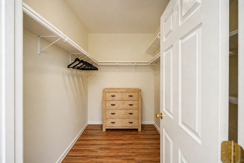 Spacious walk-in closet with clothing storage in the primary