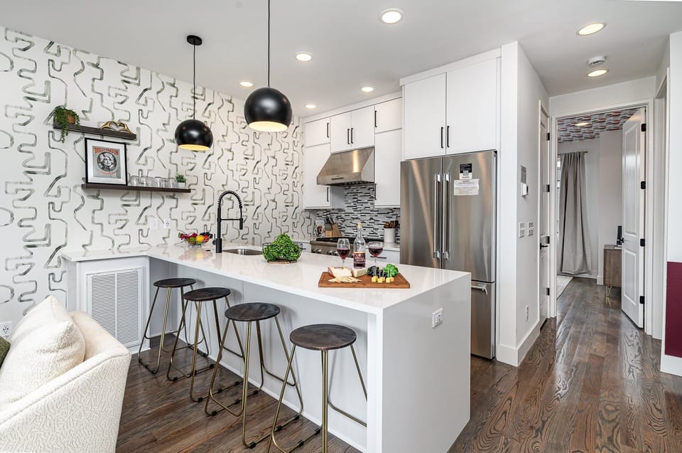 Unit 1: Fully equipped kitchen with stainless steel appliances and a kitchen island with seating for 4 guests. (2nd Floor)