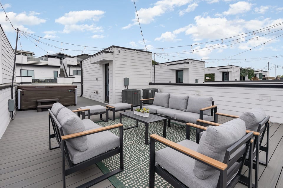 Unit 2 (4th Floor): Private Rooftop Patio featuring a hot tub and an outdoor lounge area.