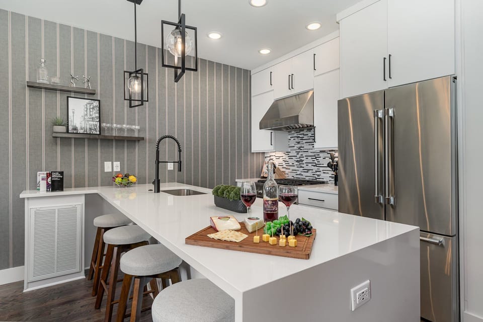 Unit 1 (2nd Floor): Fully equipped kitchen with stainless steel appliances and a kitchen island with seating for 4 guests.