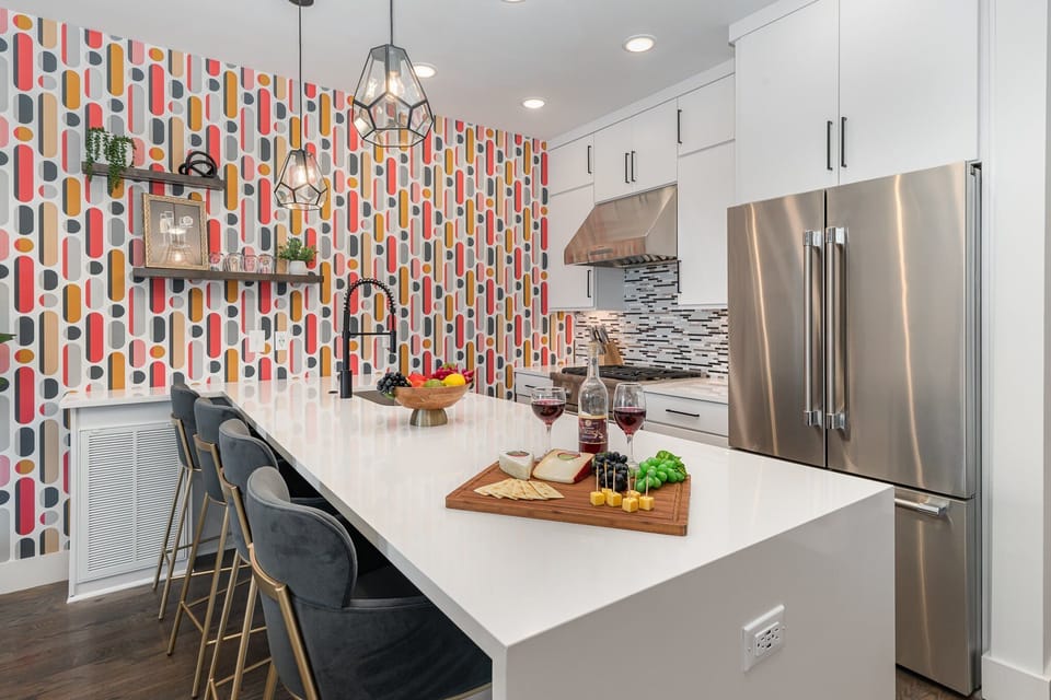Unit 2 (2nd Floor): Fully equipped kitchen with stainless steel appliances and a kitchen island with seating for 4 guests.