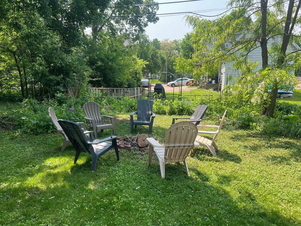 Backyard bonfire pit with 7 chairs. 